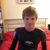 Wetsuited on bed